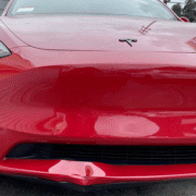 Tesla Model Y with dented right side panel after accident